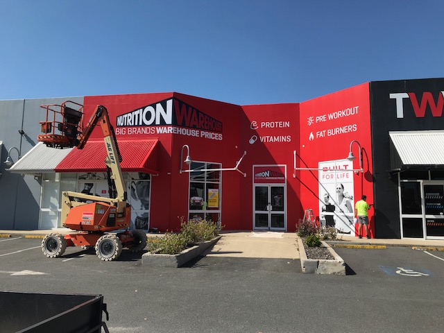 commercial painters brisbane with completed red external wall